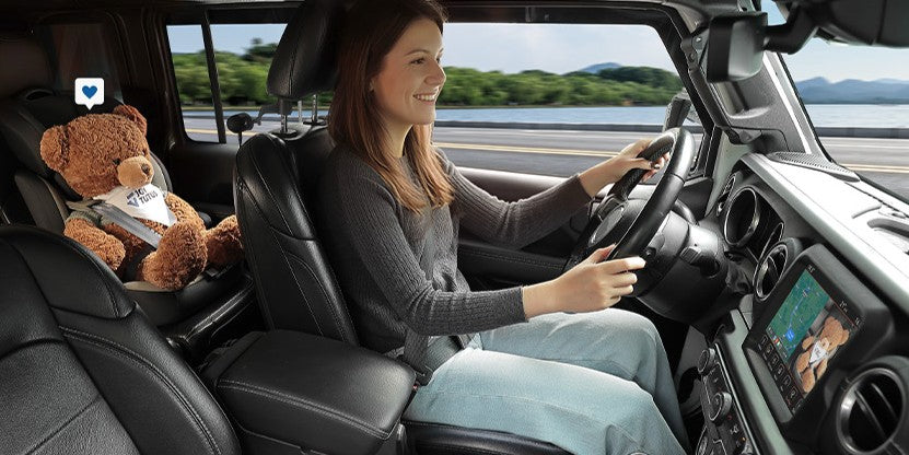 Driving woman see the bear on backseat by CarPlay Baby Monitor
