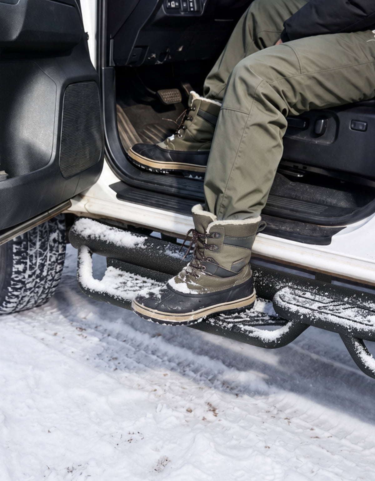A man stepping on running boards textured surface stably, the surface covered by snow